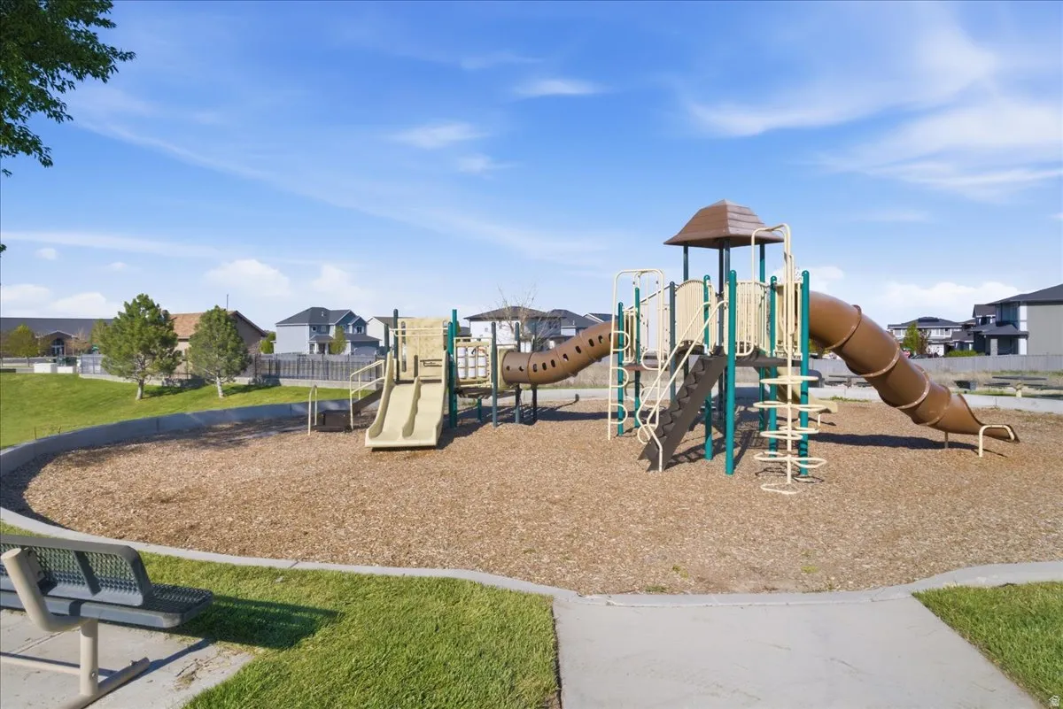 Recreational playground featuring multiple slides, climbing elements, and a ground cover of wood chips