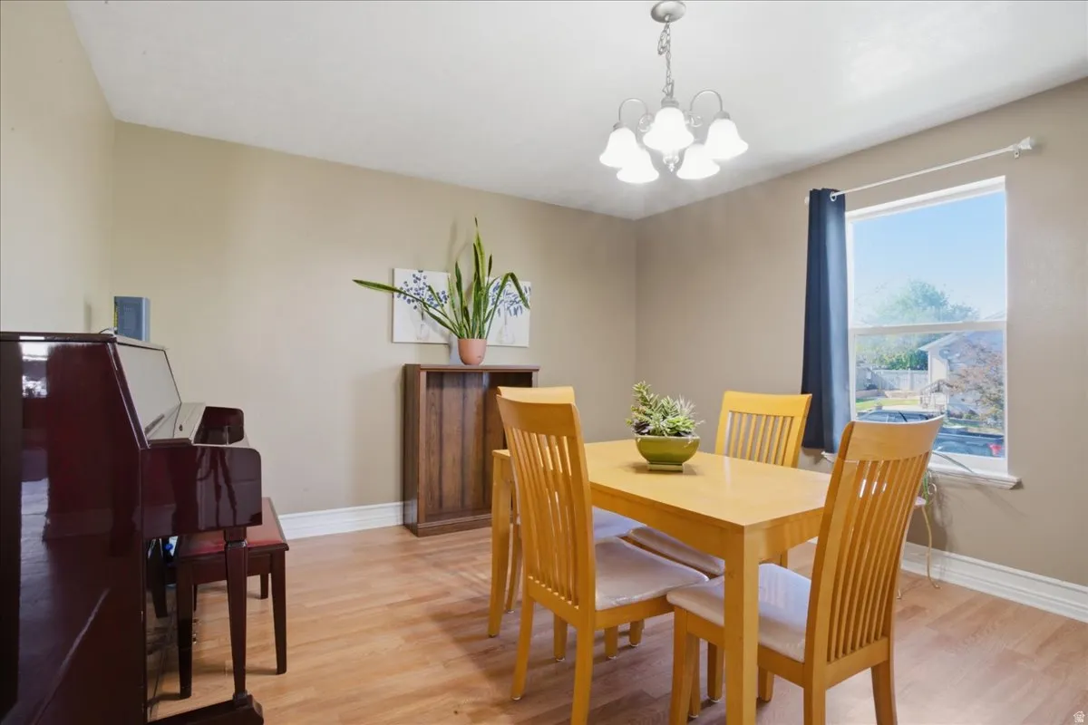 Recessed ceiling, wood-finish flooring, and a single window with a white frame