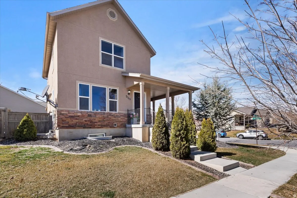 Two-story stucco exterior with stone veneer accents