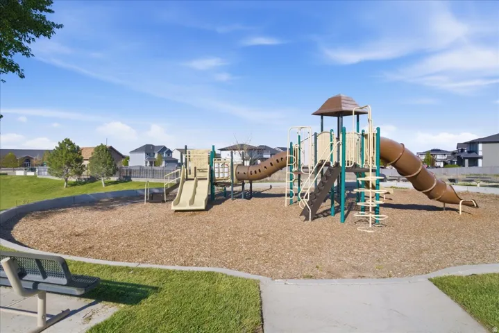 Recreational playground featuring multiple slides, climbing elements, and a ground cover of wood chips
