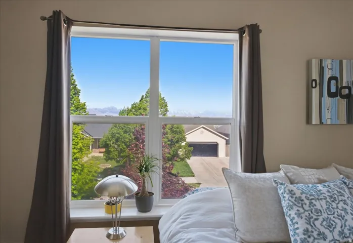 Expansive window overlooking trees and a distant mountain range