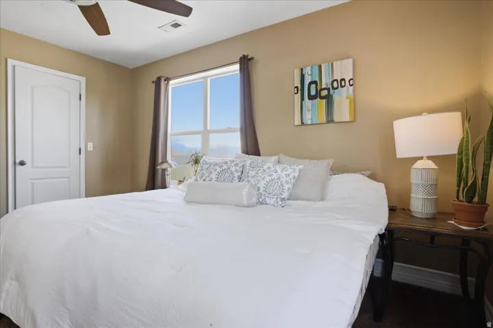 Recessed lighting, ceiling fan, neutral wall tones, window with vertical blinds, and a paneled door