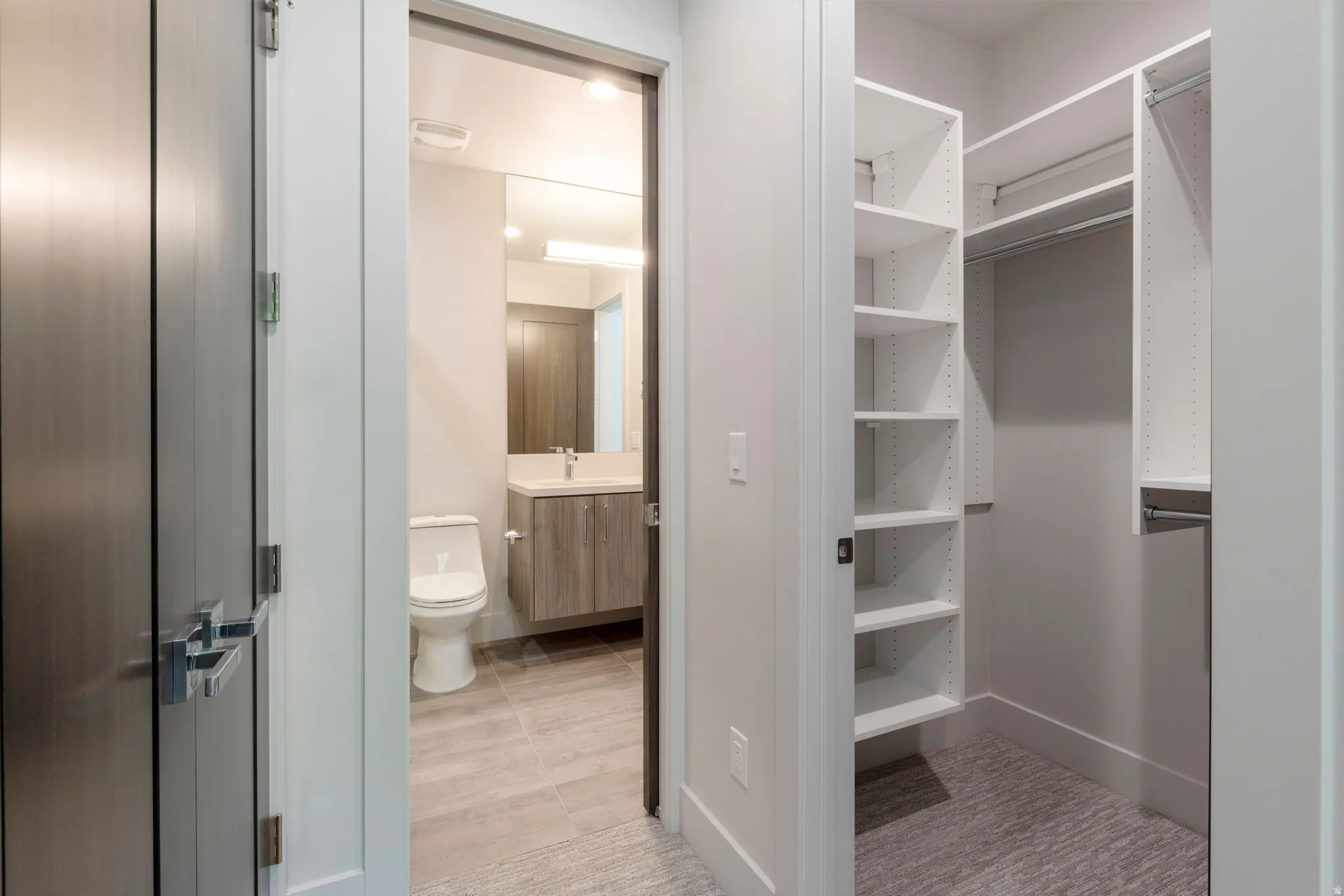 Walk-in closet with built-in shelving and hanging rods