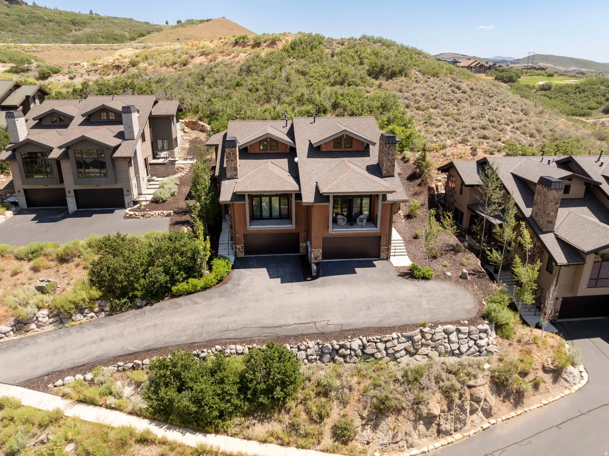 Contemporary mountain-style architecture featuring stone accents and a multi-level design