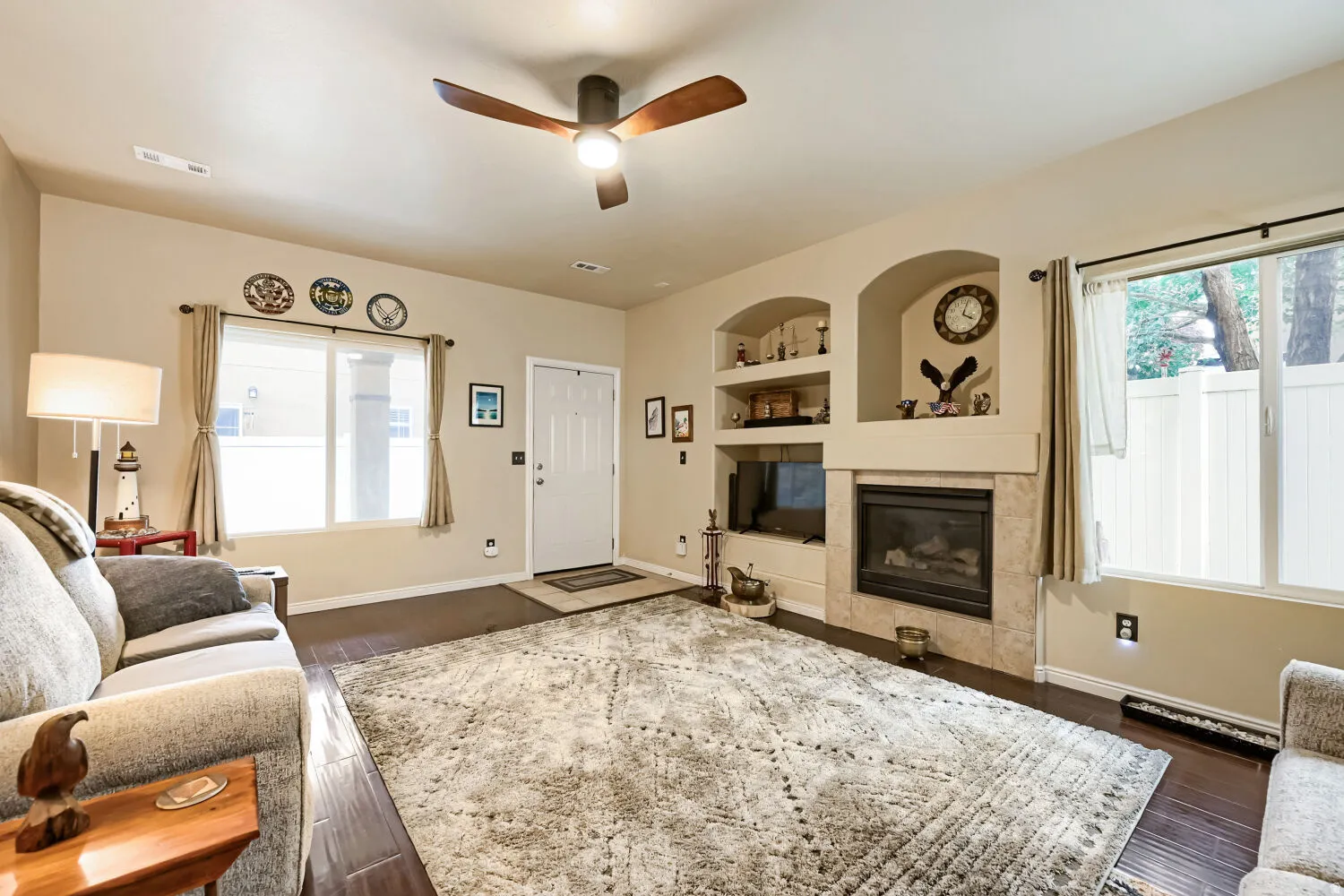 Living room with gas fireplace, tile surround and built-in display niches