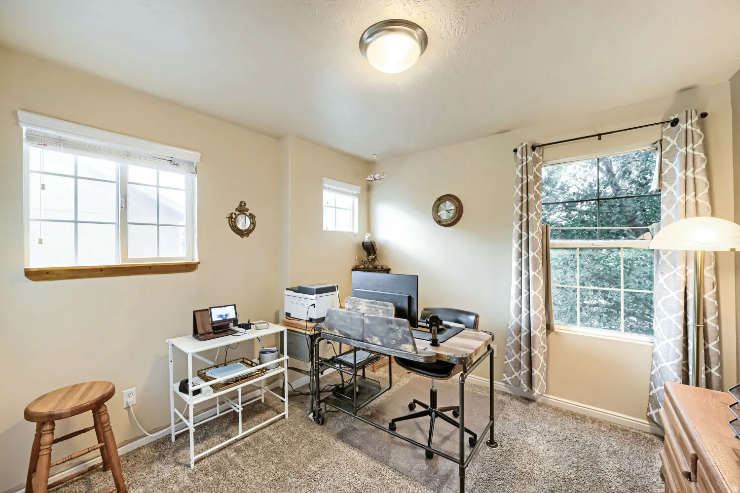 Bedroom 3, currently used as a home office, windows on two walls