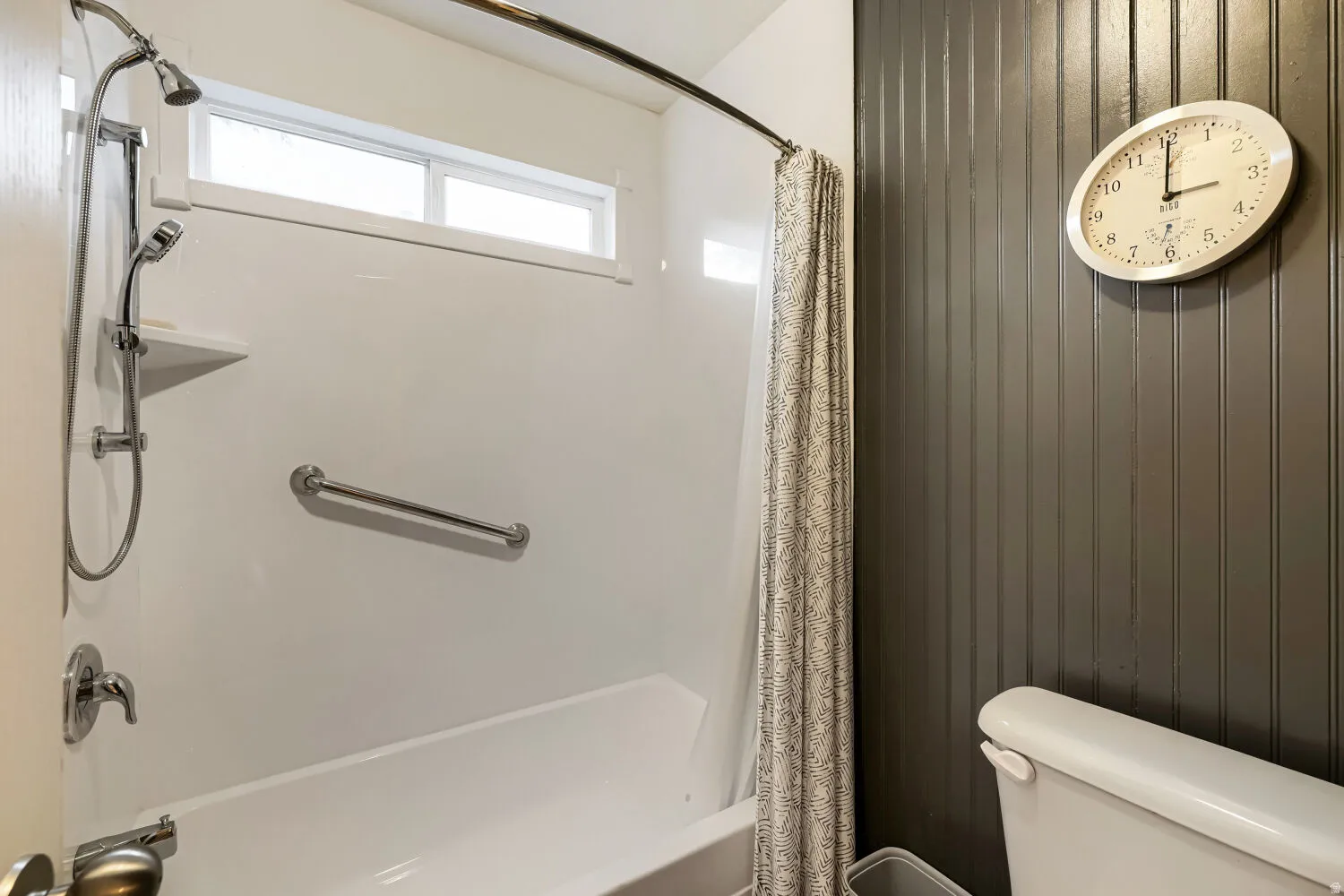 Primary tub and shower with handheld sprayer and safety bar