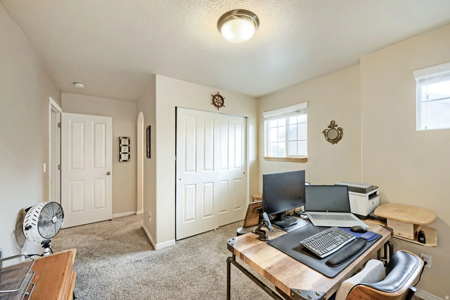 Bedroom 3, currently used as a home office, windows on two walls