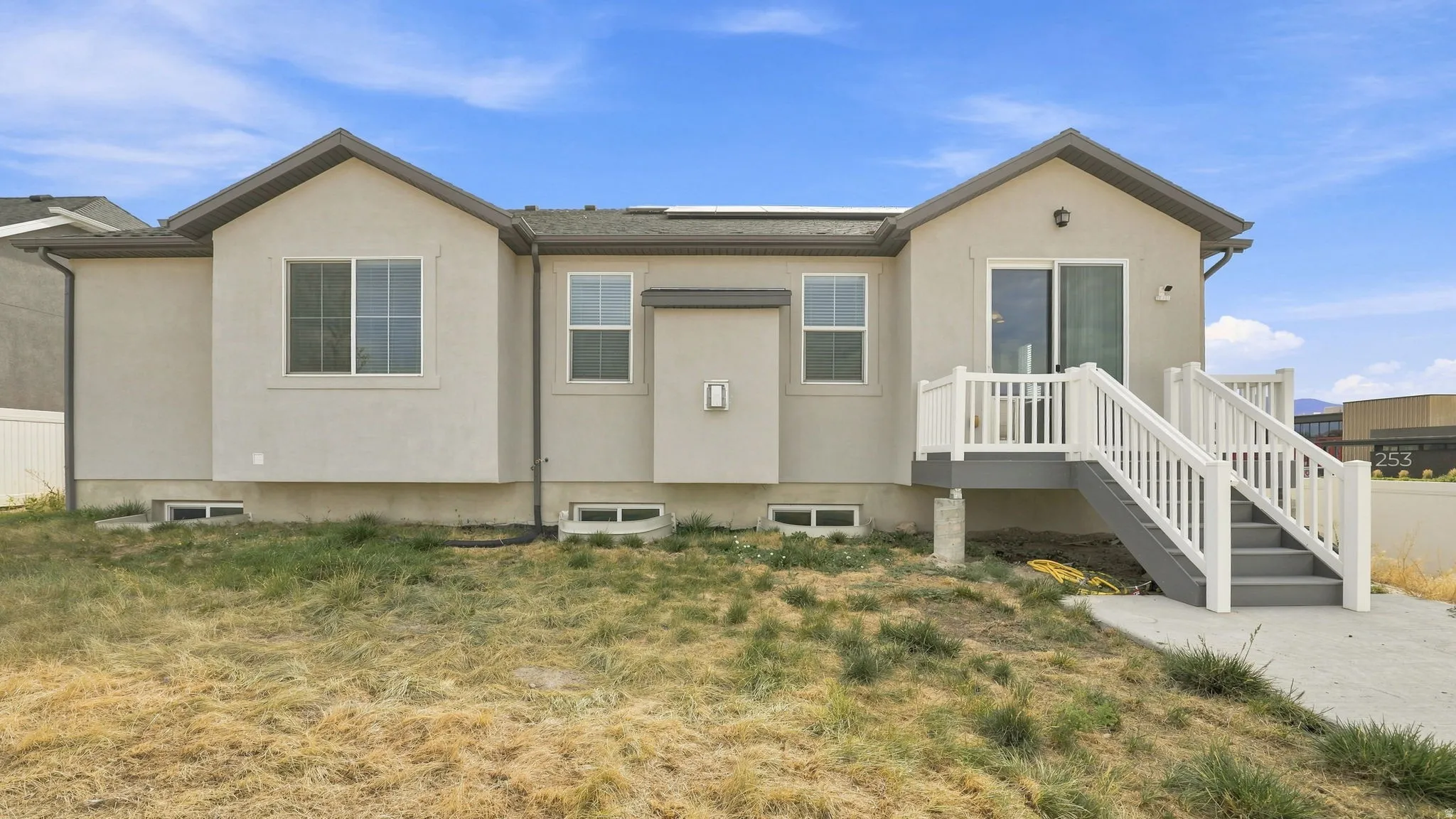 Rear exterior with stucco finish and multiple windows