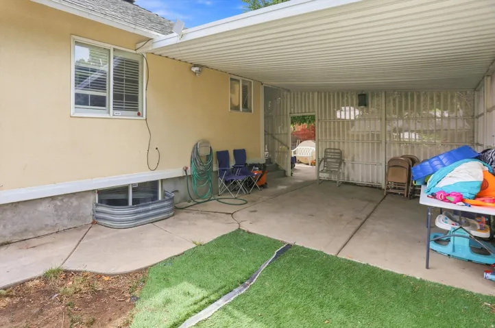 Concrete patio with an attached covered awning and a privacy wall