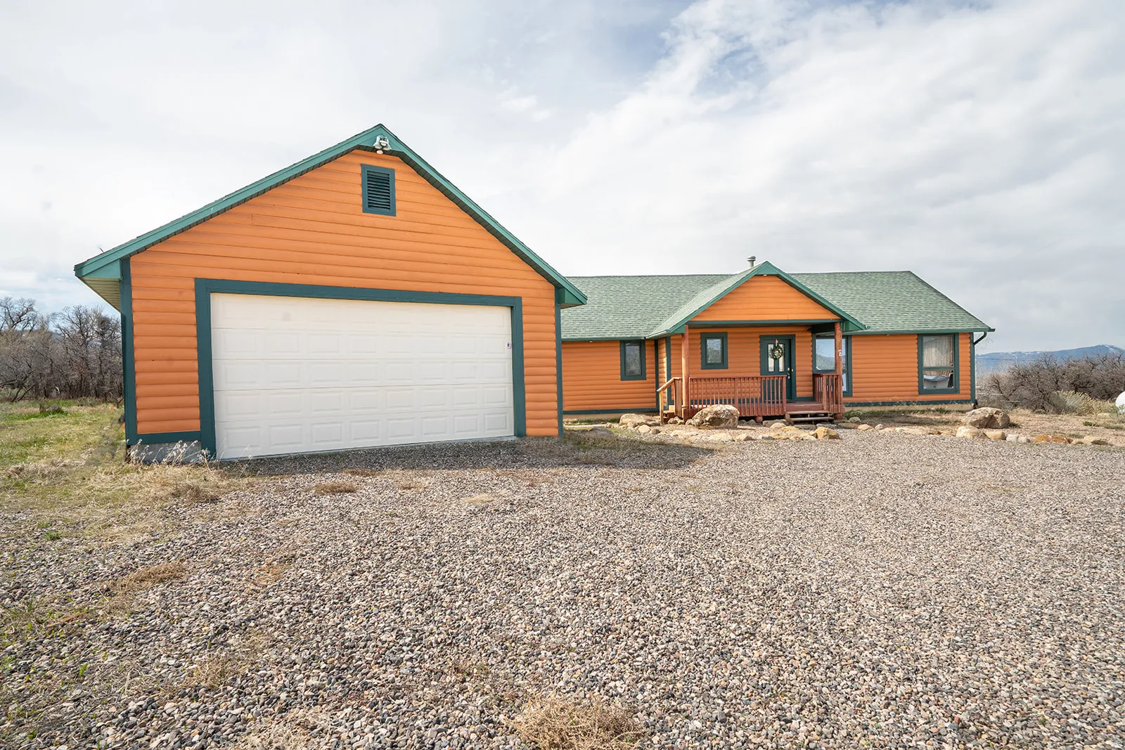Orange siding exterior with a green shingle roof