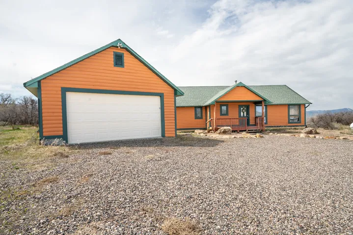 Orange siding exterior with a green shingle roof