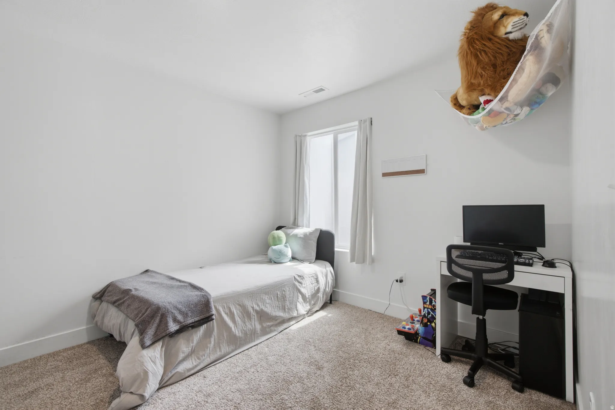 Carpeted flooring, white walls, and a window with white trim