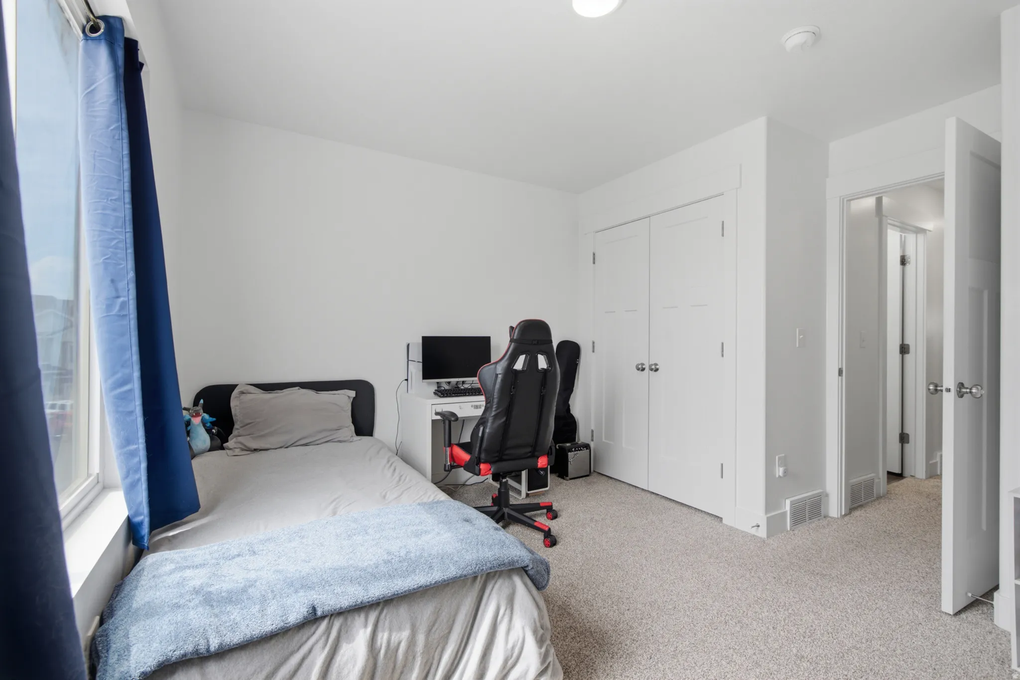 Neutral wall paint, carpeted flooring, built-in closet with double doors, recessed lighting, and a window