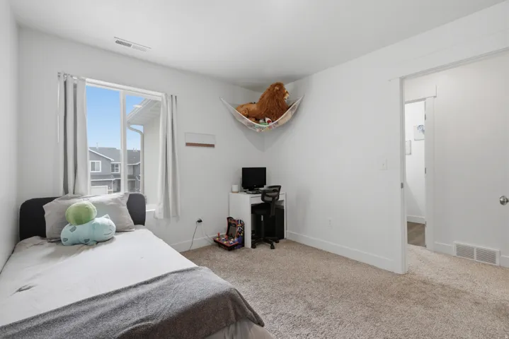 Recessed window with white trim, light-colored walls, and carpet flooring