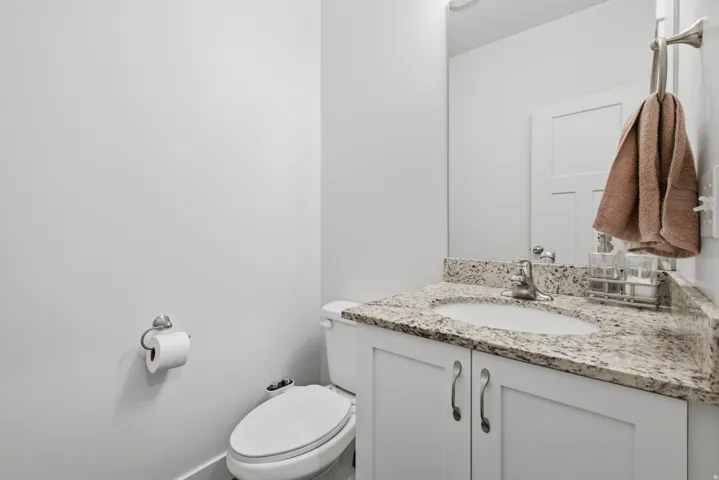 Vanity with a speckled countertop, undermount sink, and chrome faucet