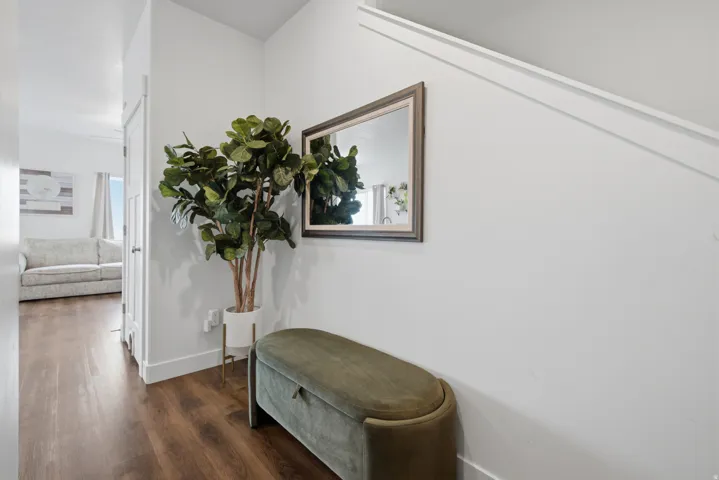 Hardwood-finish flooring, white walls, and bright overhead lighting