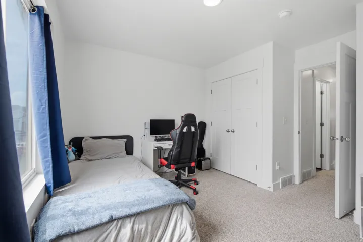 Neutral wall paint, carpeted flooring, built-in closet with double doors, recessed lighting, and a window