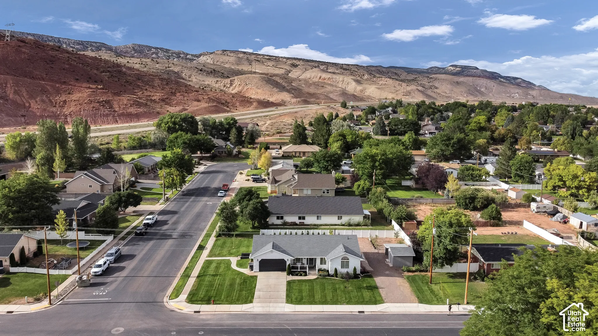 Suburban setting with mountain backdrop and mature trees