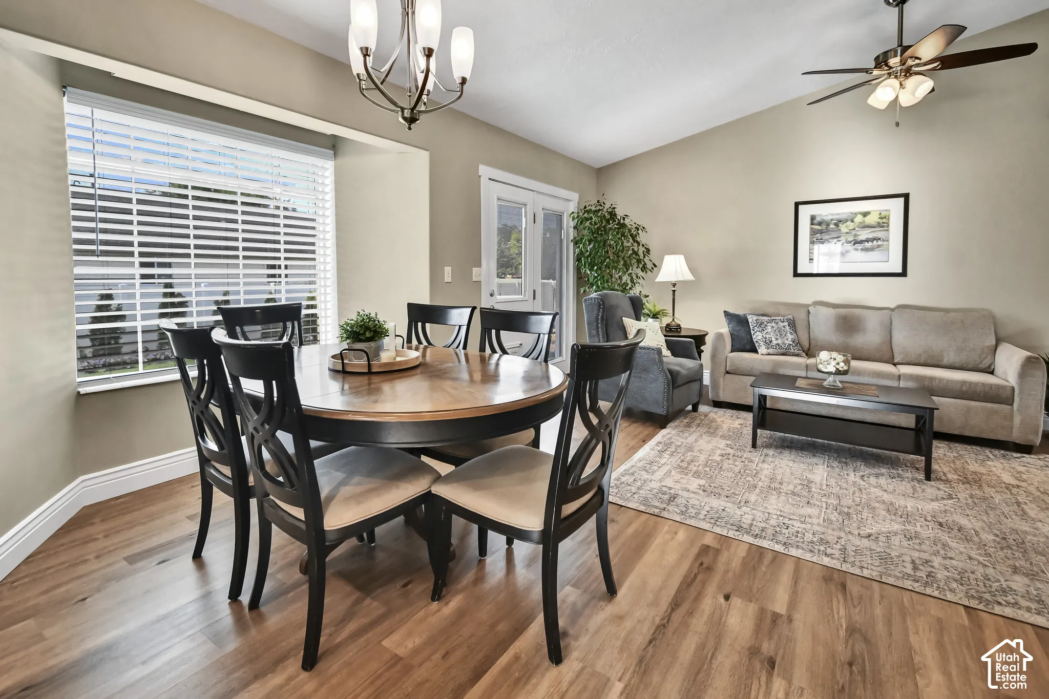 Wood-finish flooring throughout, complemented by a contemporary ceiling fan with lighting