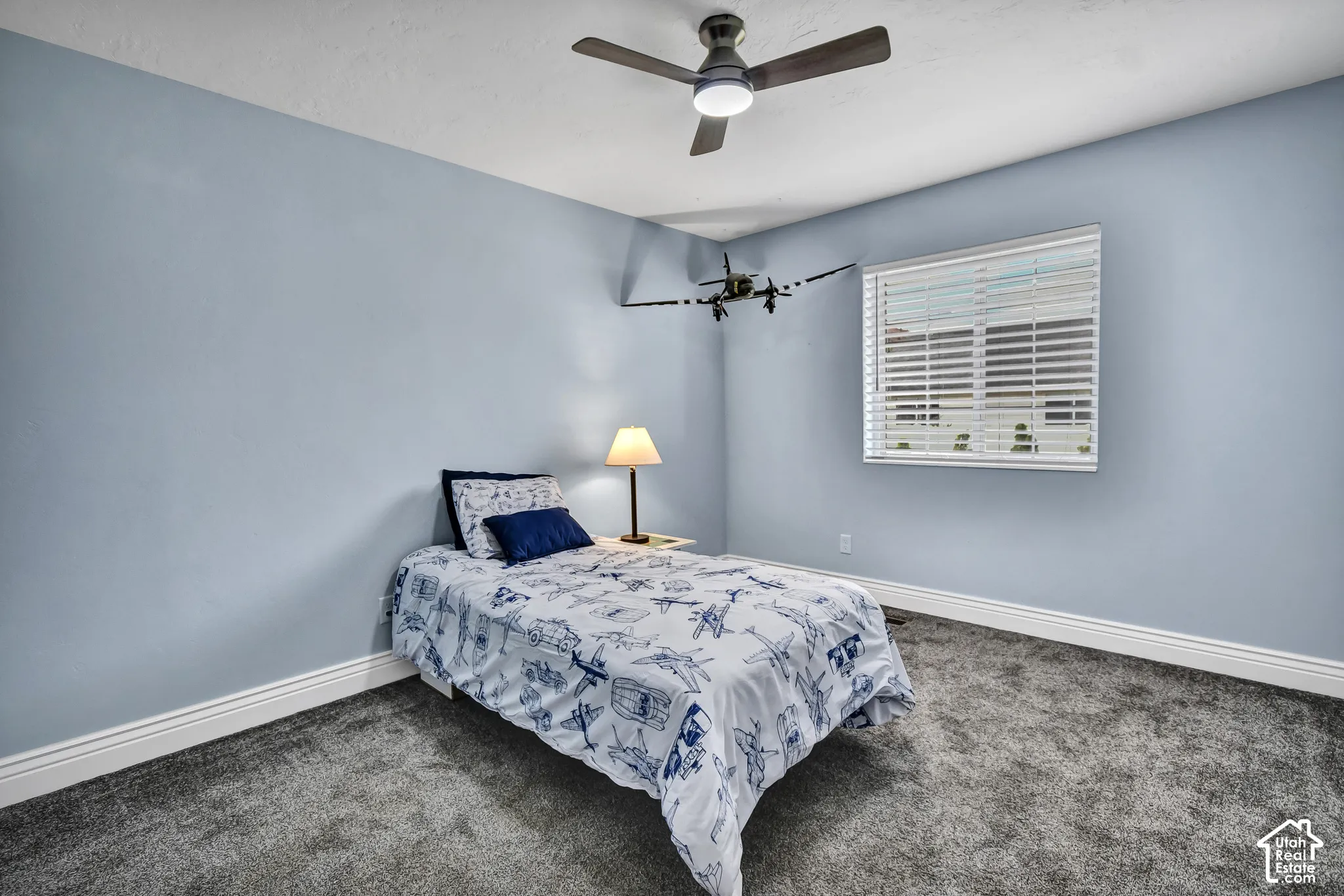 Powder blue walls complement the grey carpet flooring