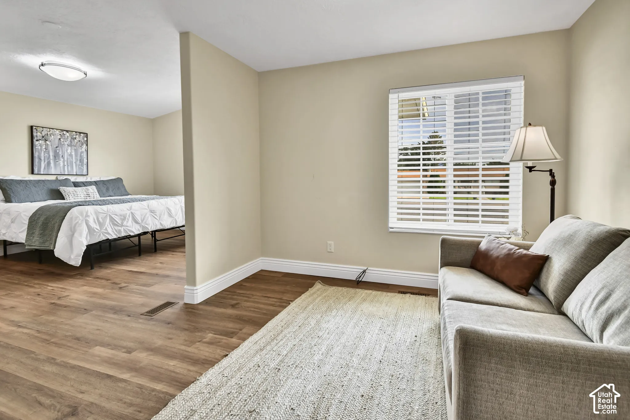 Wood-finish flooring throughout, complemented by light-toned wall paint and white trim