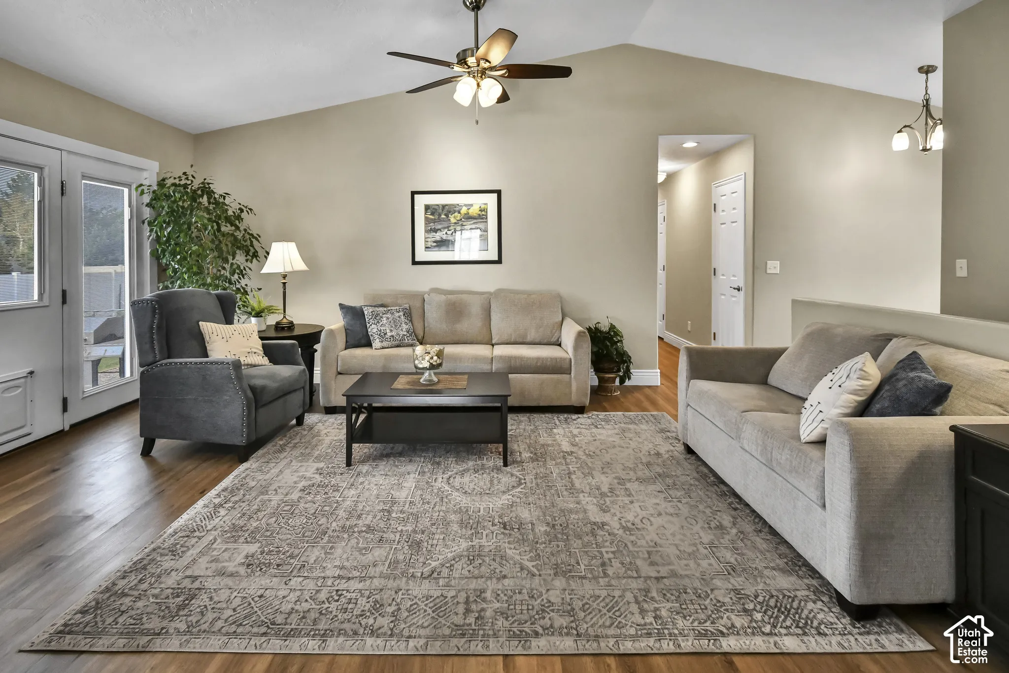 Vaulted ceiling with a ceiling fan, wood-finish flooring, and French doors