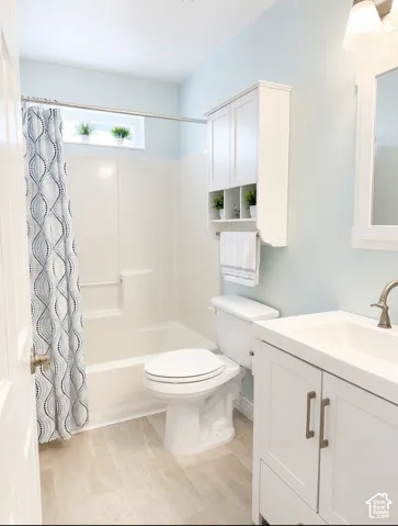 White vanity with brushed nickel hardware, integrated sink, and brushed nickel faucet