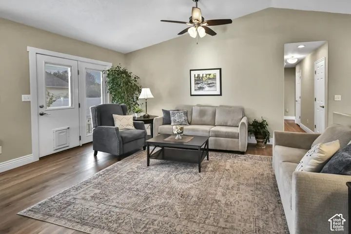 Vaulted ceilings, wood-finish flooring, and a ceiling fan with integrated lighting