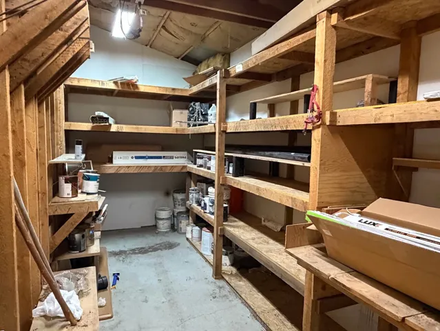 Expansive storage room featuring custom-built shelving and overhead lighting