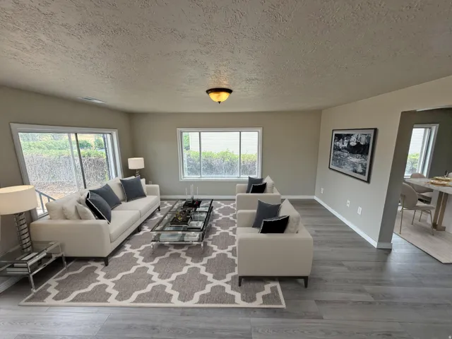Wood-finish flooring, recessed lighting, and large windows with natural light
