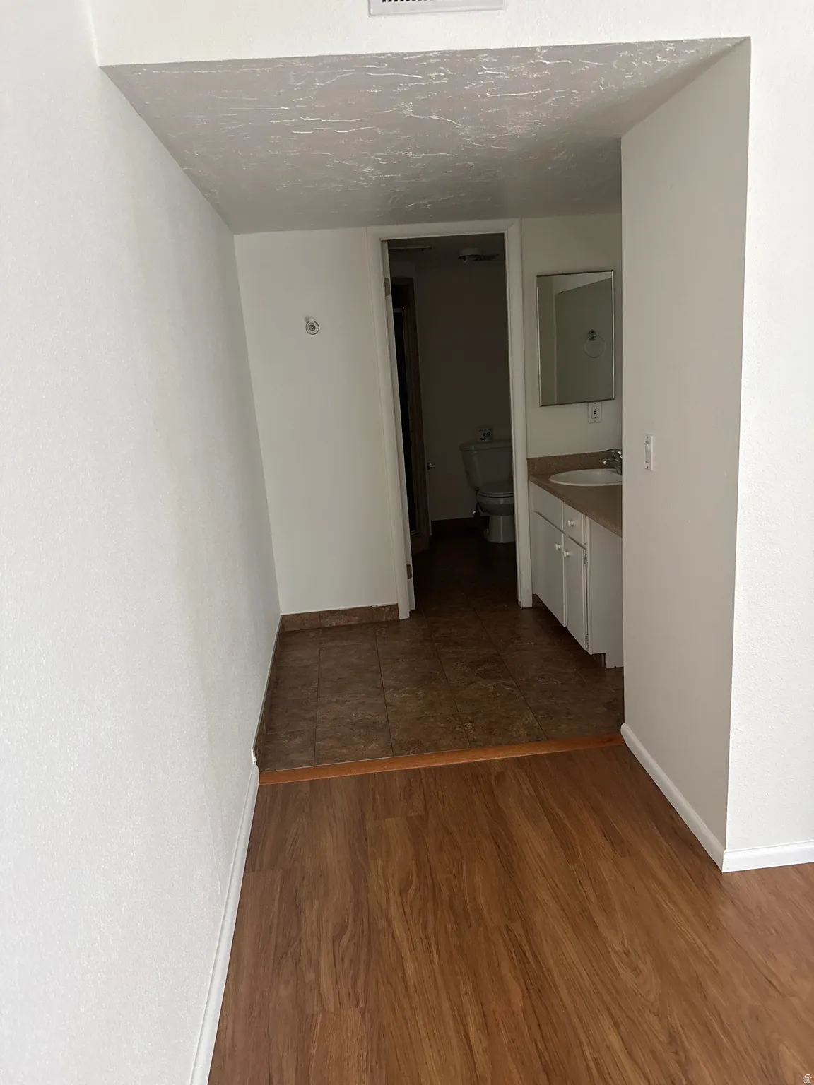 Wood-finish flooring transitions to tile