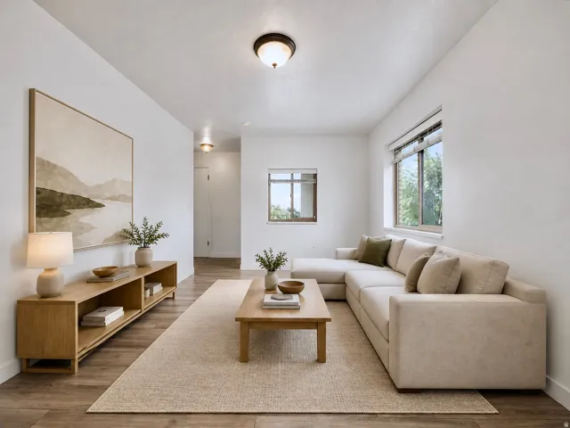 Wood-finish flooring throughout, bright white walls, and multiple windows providing natural light