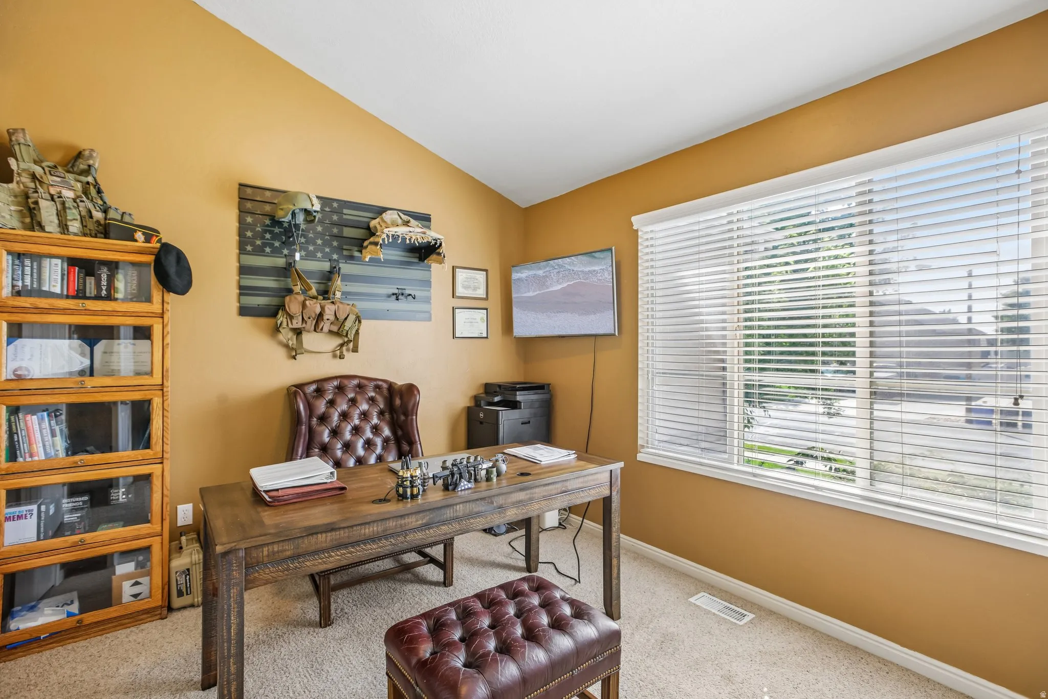 Warm-toned walls with a sloped ceiling and recessed lighting