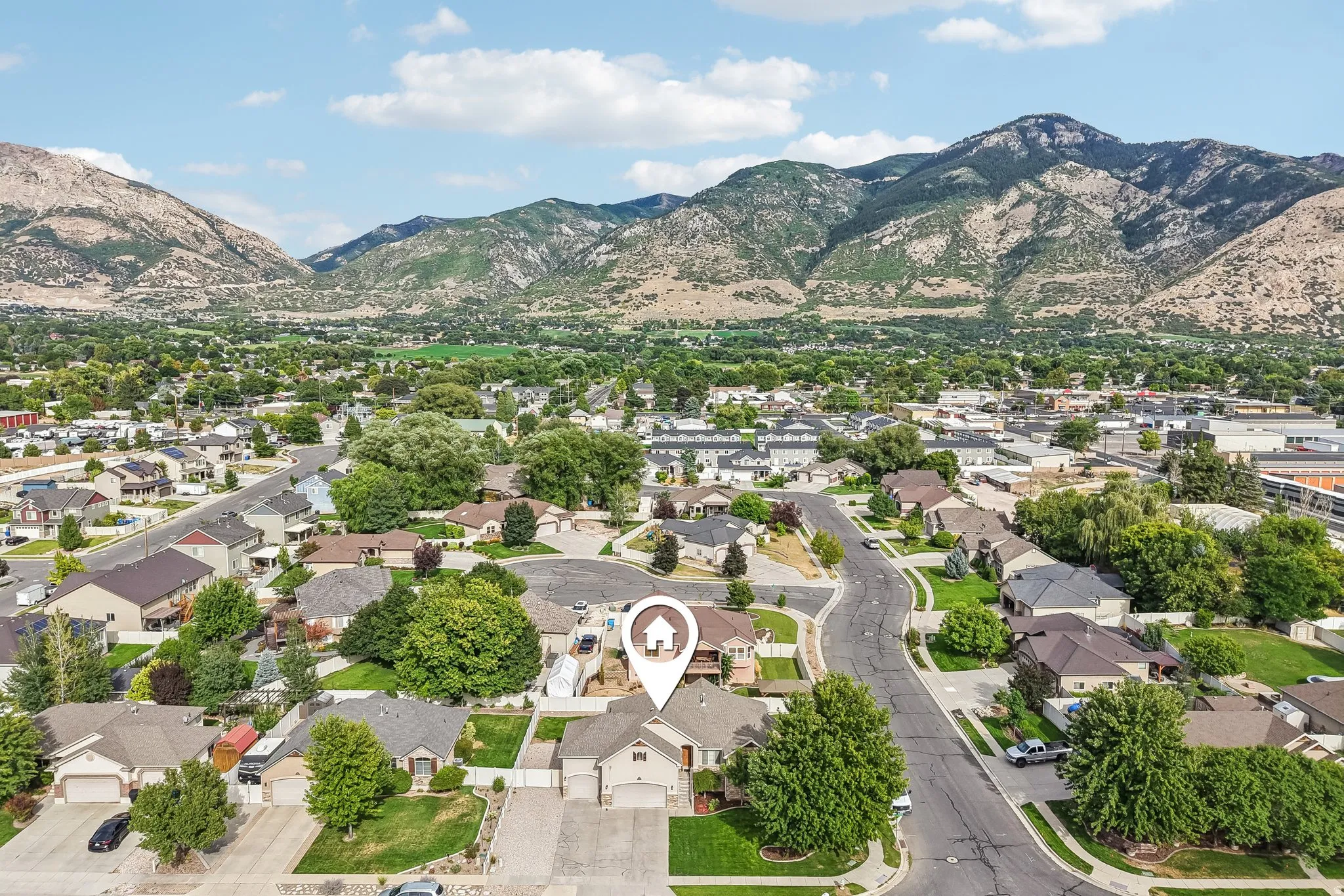 Residential neighborhood with mountainous backdrop and mature landscaping