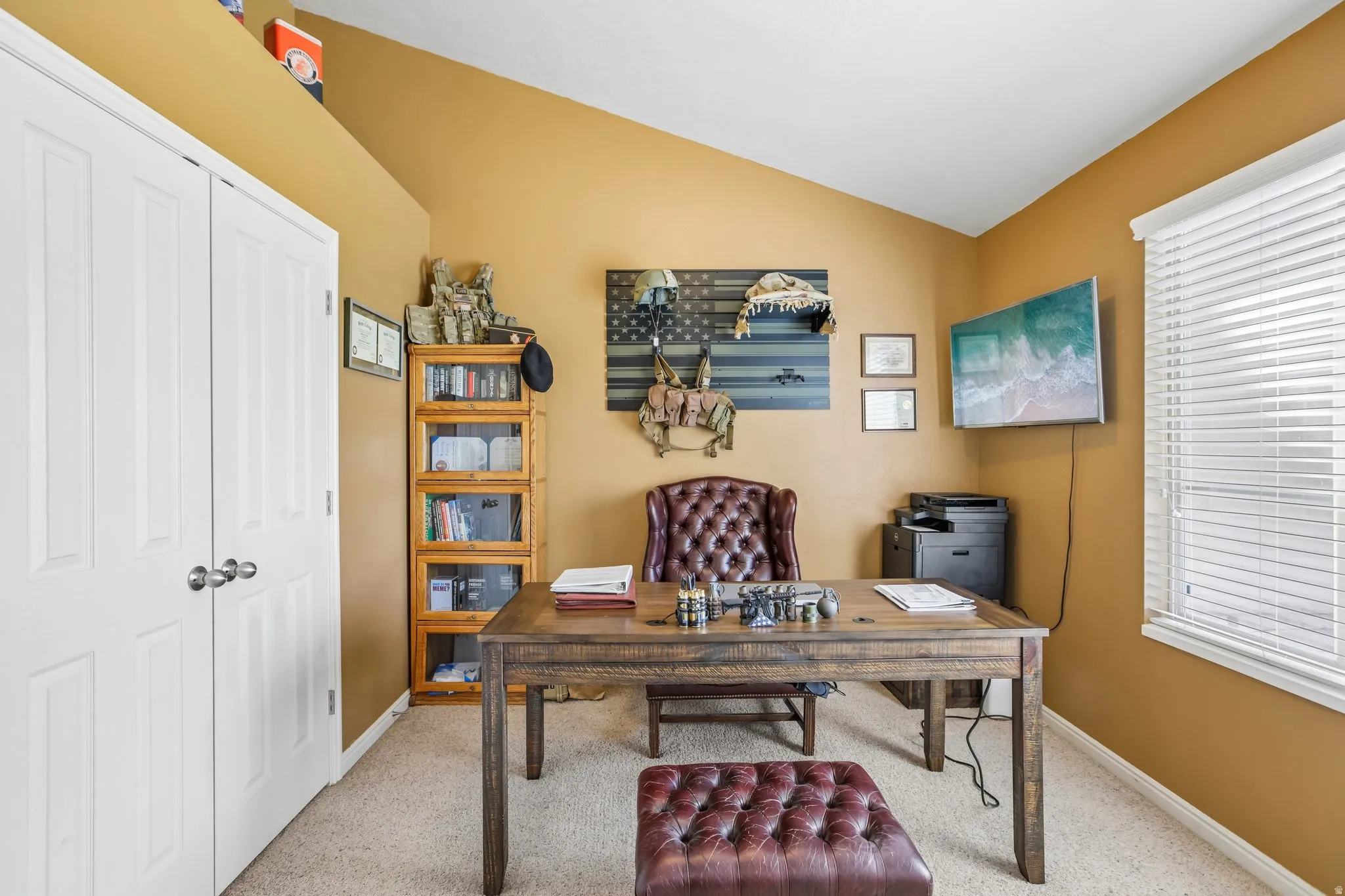 Sloped ceiling with recessed lighting, light-colored carpeting, a window with horizontal blinds, and white bi-fold closet doors
