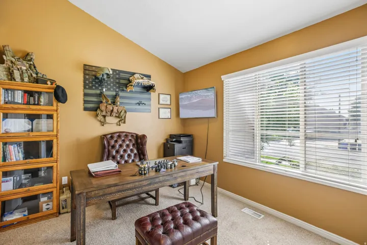 Warm-toned walls with a sloped ceiling and recessed lighting