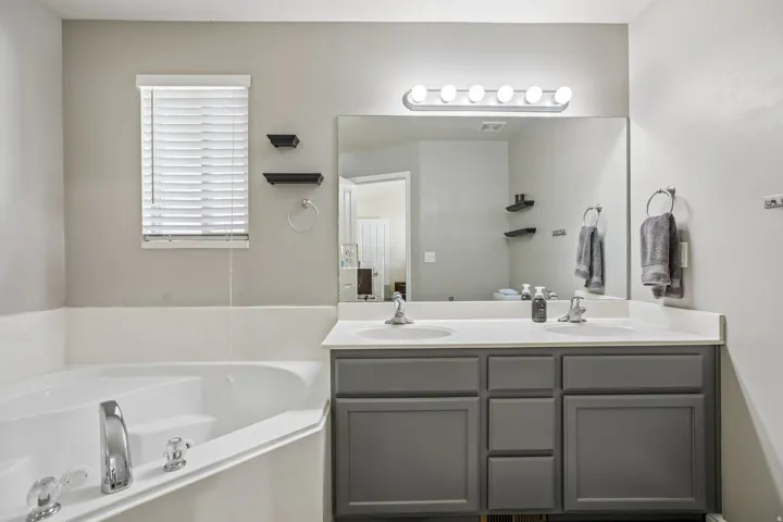 Corner soaking tub with chrome fixtures