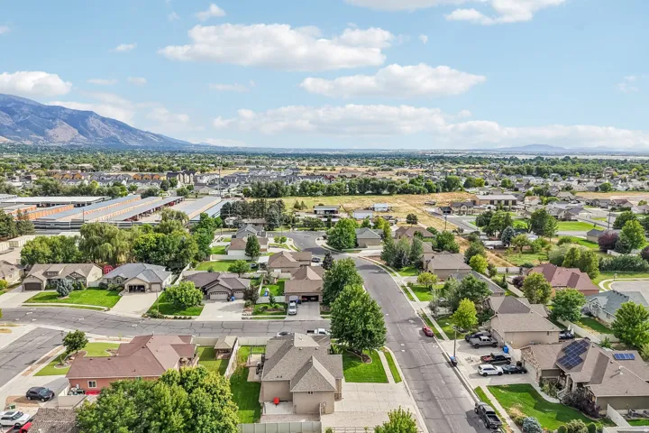 Residential neighborhood with mature trees and mountain backdrop