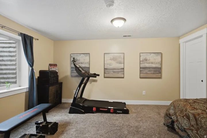Recessed window with white trim, tan wall paint, and gray carpet flooring