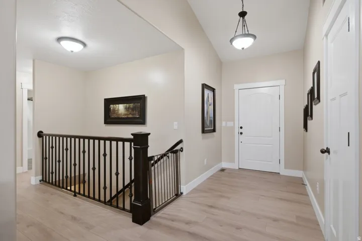 Light wood-finish flooring with white trim