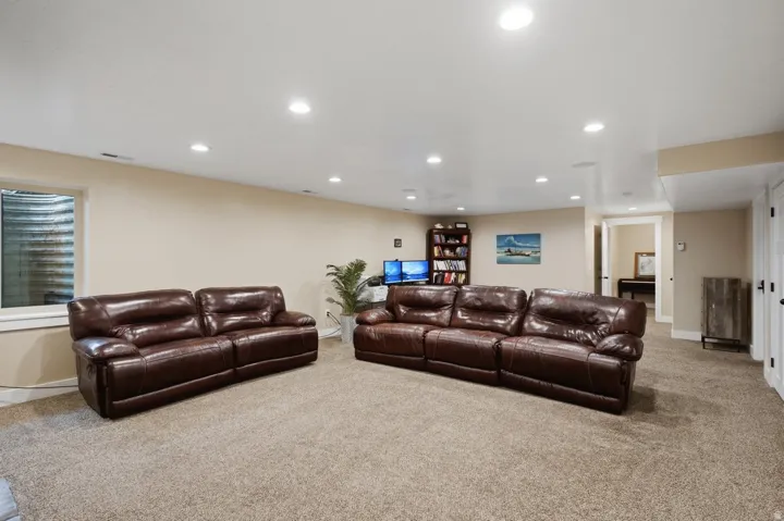 Recessed lighting, neutral wall tones, and carpeted flooring