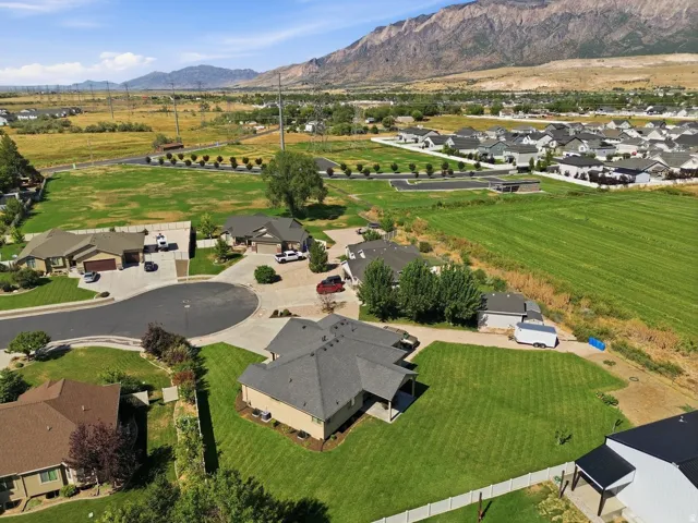 Cul-de-sac location with established landscaping, paved driveways, and mountain scenery