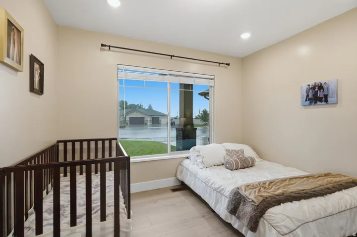 Recessed lighting illuminates neutral-toned walls and wood-finish flooring
