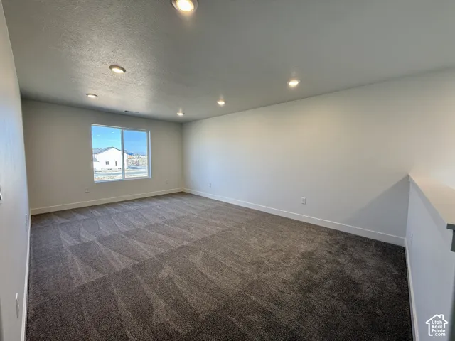 Spacious interior featuring recessed lighting, neutral wall paint, and wall-to-wall carpeting