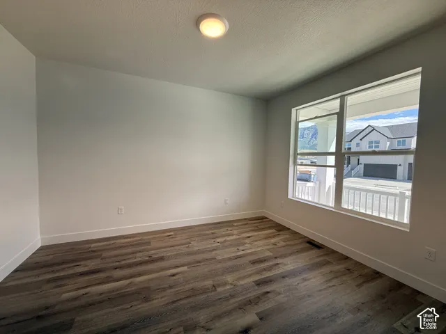 Recessed ceiling light fixture, wood-finish flooring, and white trim
