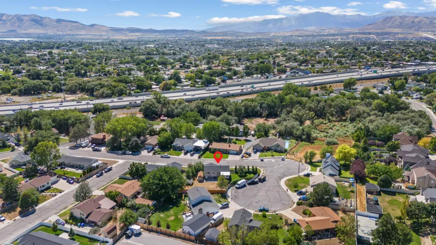Mountain backdrop, residential area, cul-de-sac street, mature trees