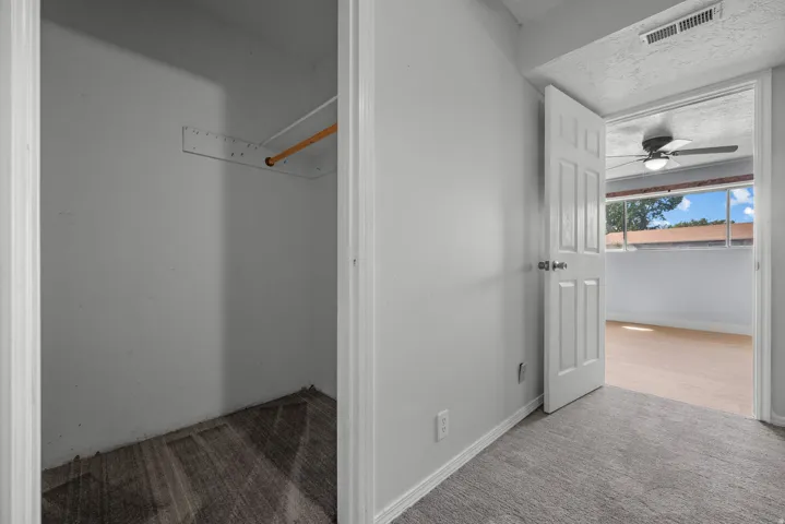 Wall-to-wall carpeting and a spacious closet with a wood rod