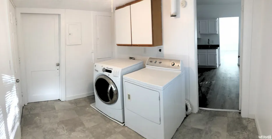 Laundry area with upper cabinetry and a tiled floor