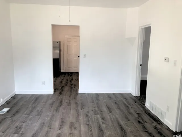 Wood-finish flooring throughout, white walls, and white trim